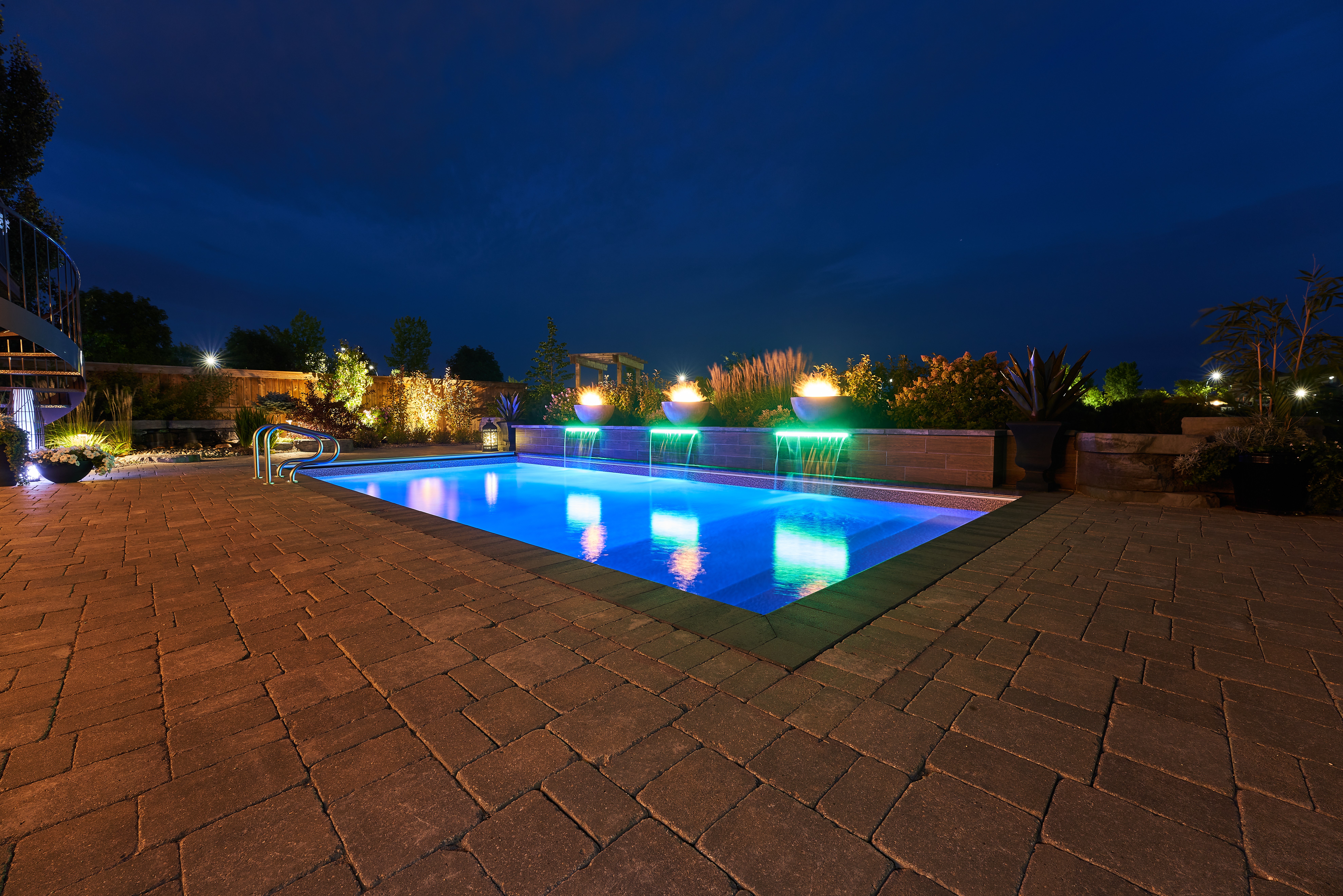 backyard pool lit at night