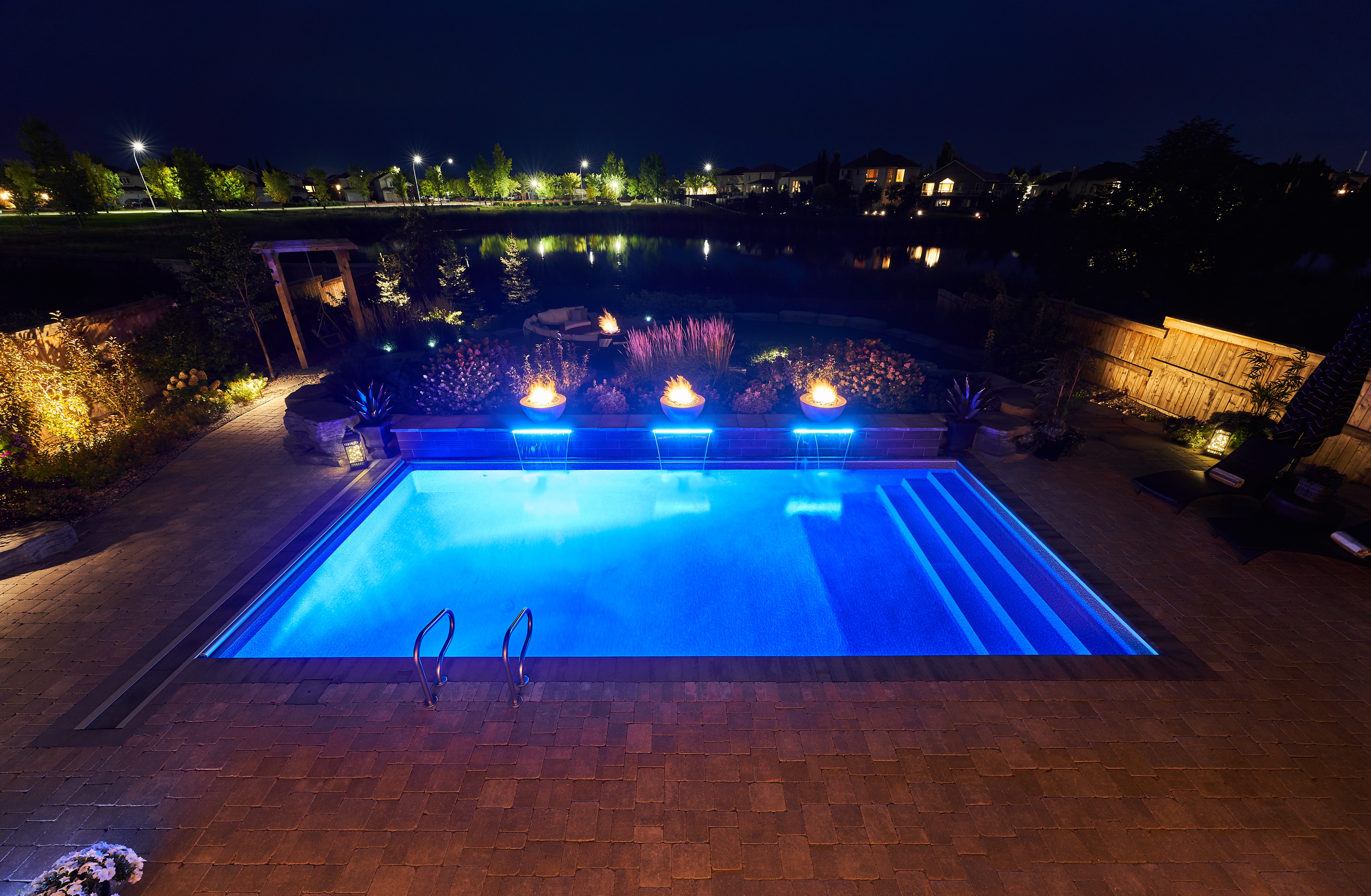 backyard pool lit at night