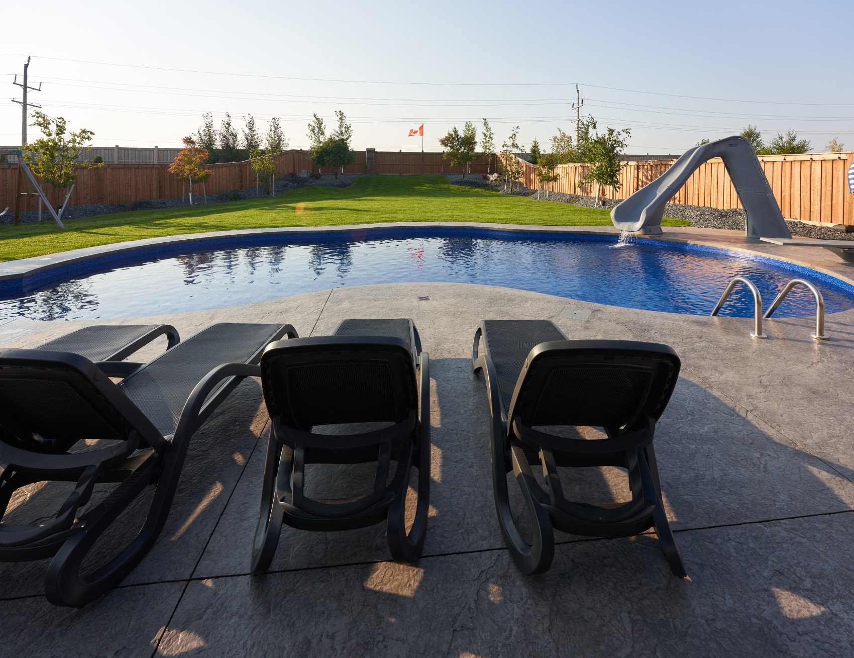 backyard pool with chairs
